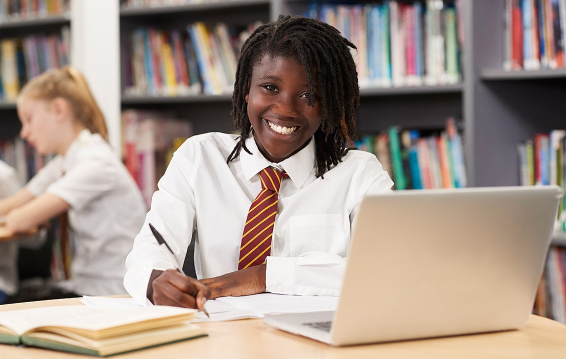 Student looking happy while working from computer